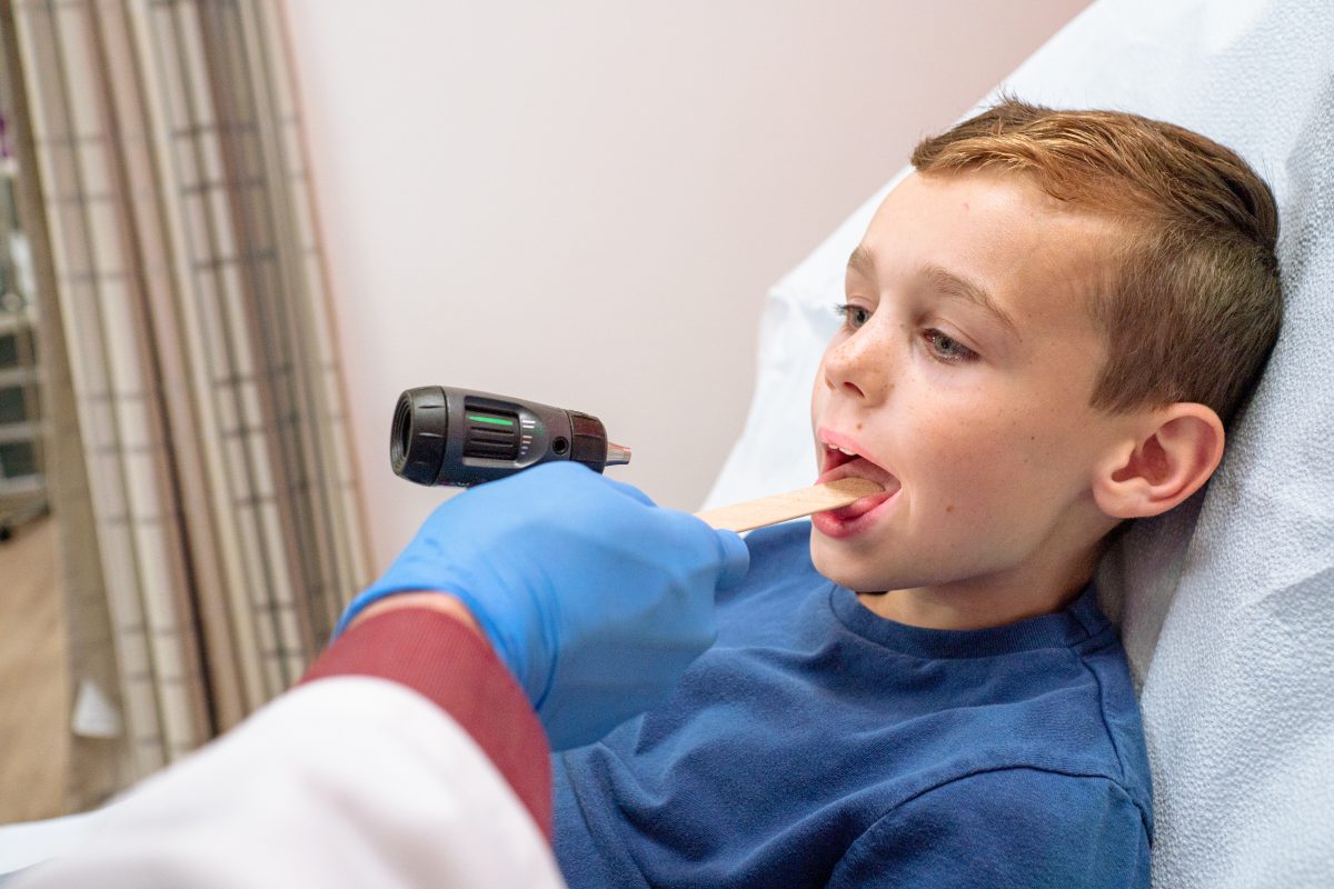 Child patient being examined for strep throat at AFC Huntersville Child patient being examined for strep throat at AFC Huntersville
